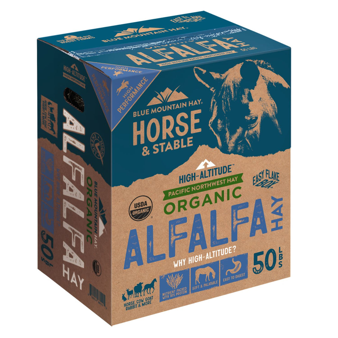A 50 lb box of Blue Mountain Hay Horse & Stable Alfalfa Hay, featuring a blue and kraft brown design with a horse illustration.