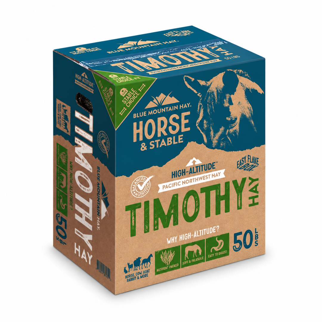 A 50 lb cardboard and blue box package of Timothy Hay from Blue Mountain Hay, featuring a horse illustration and product details on a white background.